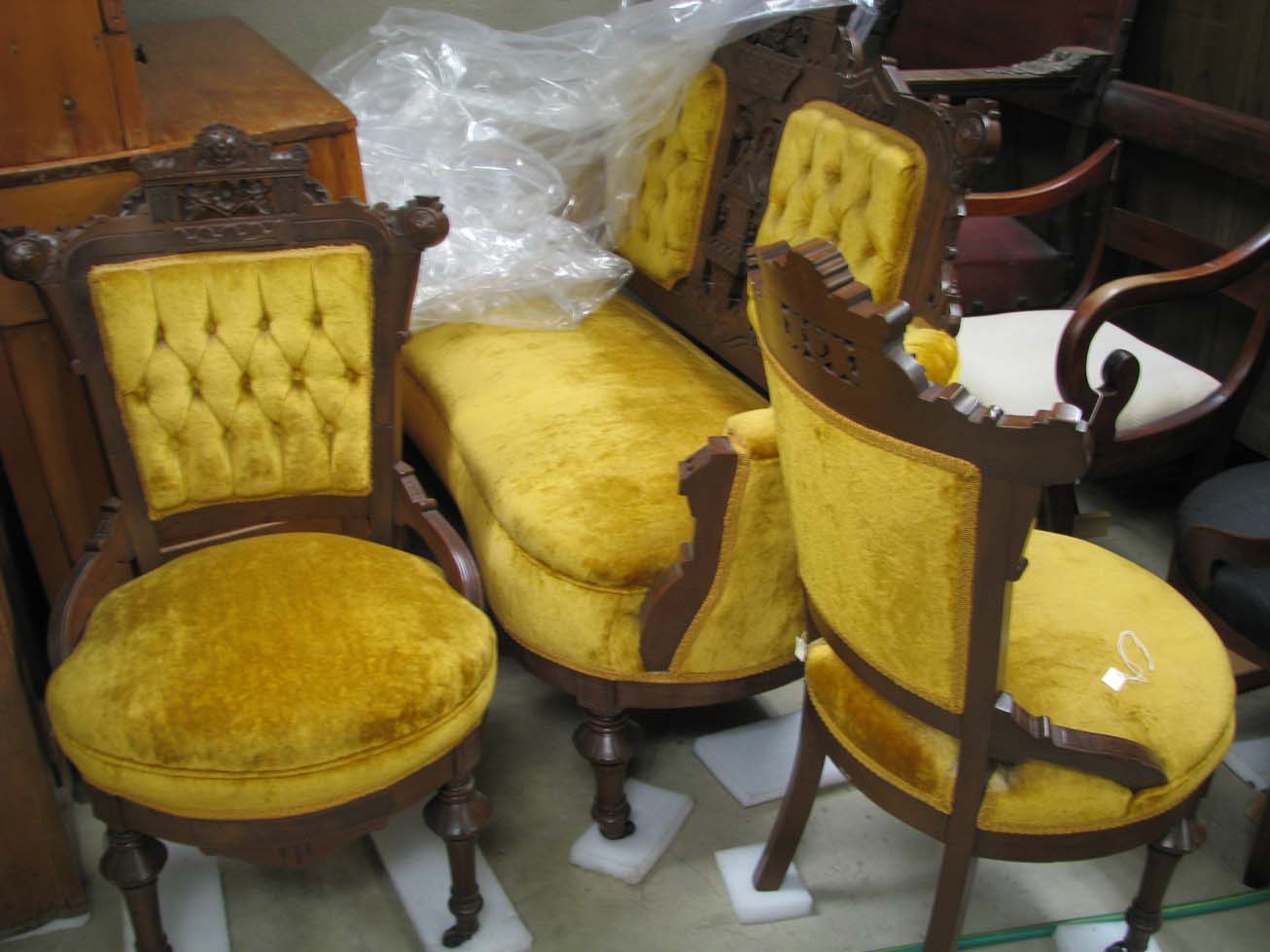 a%20wooden%20and%20yellow%20velvet%20cushioned%20love%20seat